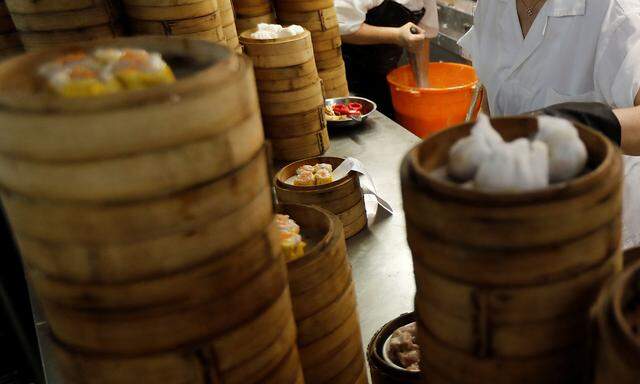 Women work in the kitchen of a dim sum restaurant in Hong Kong,