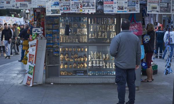 March 28, 2024, Athens, Greece: A man reads the newspapers hanging at a kiosque. Hundreds of employees at the state owned mining and metallurgical company, Larco, along with their families, staged a demonstration to protest over the governmentÃââ s plans to sell the company fro scap. Athens Greece - ZUMAg221 20240328_zap_g221_014 Copyright: xNikolasxGeorgioux