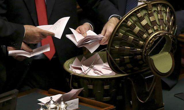 Assistants open a ballot box at the end of the vote session at the Chambers of Deputies in Rome