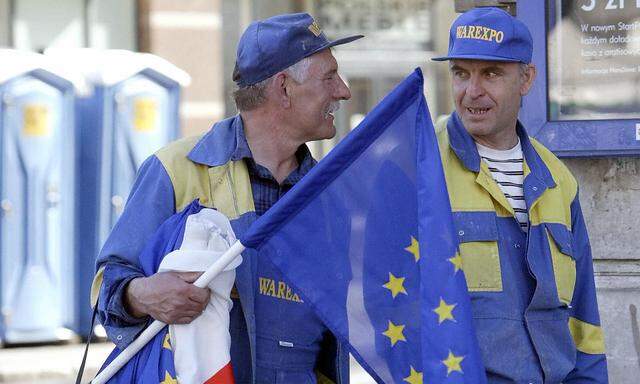 Workers carrying Polish national and EU