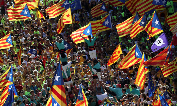 Castellers form a human tower called a ´castell´ as thousands of people gather for a rally on Catalonia´s national day ´La Diada´ in Barcelona