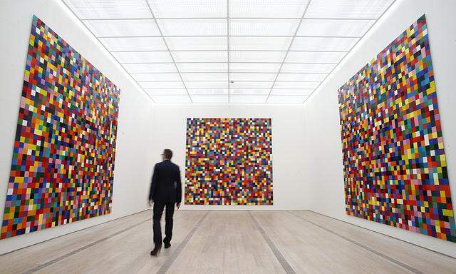 A man walks in front of the enamel on alu dibond ´4900 Colors´ by German artist Richter at the Fondation Beyeler in Riehen