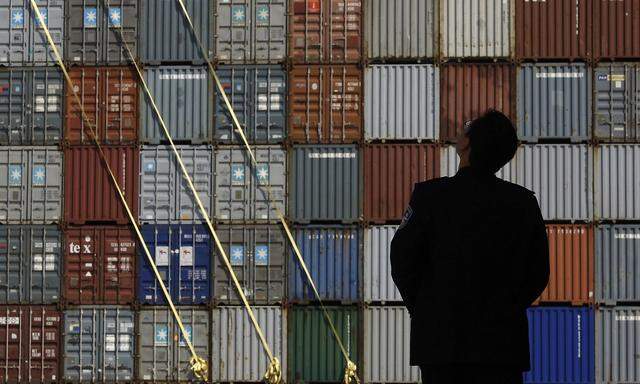 Security guard stands in front of the Yantian International Container Terminal in the southern Chinese city of Shenzhen