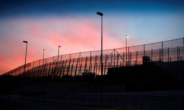 FILE PHOTO: The border fence between Morocco and Spain's north African enclave Melilla is seen along a road