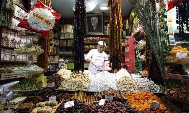 A Turkish vendor sells dates and dried fruits at the Egyptian Bazaar during preparations for the upcoming holy month of Ramadan, in Istanbul