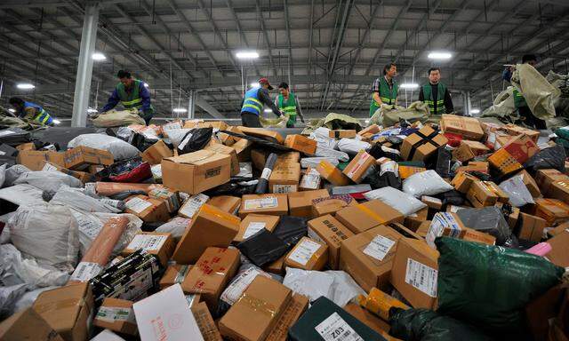 Employees sort boxes and parcels at a logistic centre of BEST Express delivery company, after the Singles´ Day online shopping festival, in Jinan