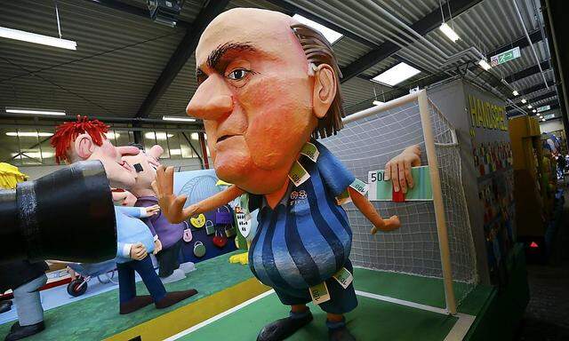 A papier mache caricature figure for a carnival float depicting suspended FIFA president Sepp Blatter  is prepared for Rose Monday carnival parade in Cologne