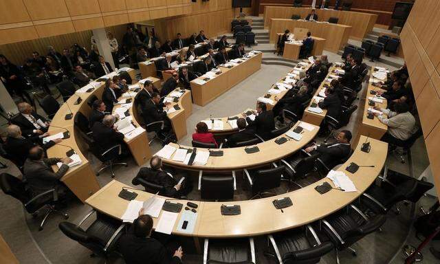 Lawmakers participate in a parliamentary session in Nicosia