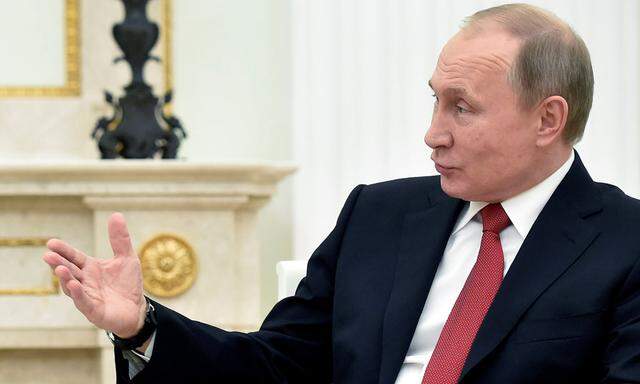 Russian President Putin gestures as he speaks during a meeting with Khadzhimba (not pictured), the leader of Georgia´s breakaway region of Abkhazia, at the Kremlin in Moscow