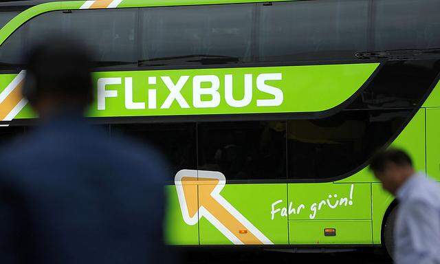 Passengers walk near Flixbus bus at main bus station in Berlin
