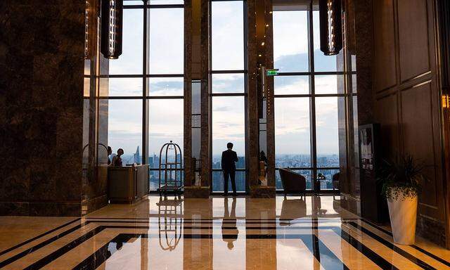 A man is silhouetted in a marble lobby of a luxury hotel in Ho Chi Minh City Vietnam on August 23