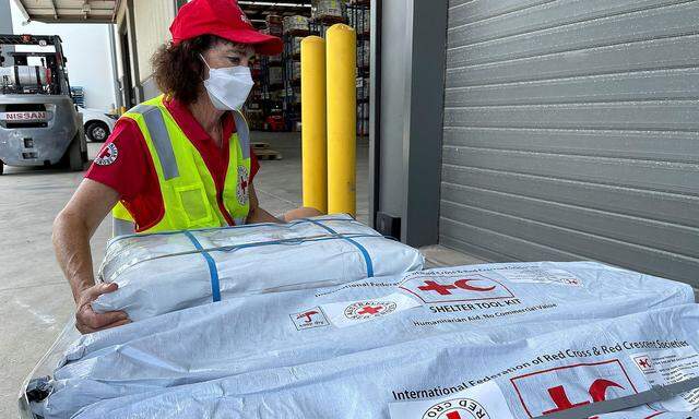 Supplies intended as relief material are prepared to be sent to Tonga by the Australian Red Cross, in Brisbane