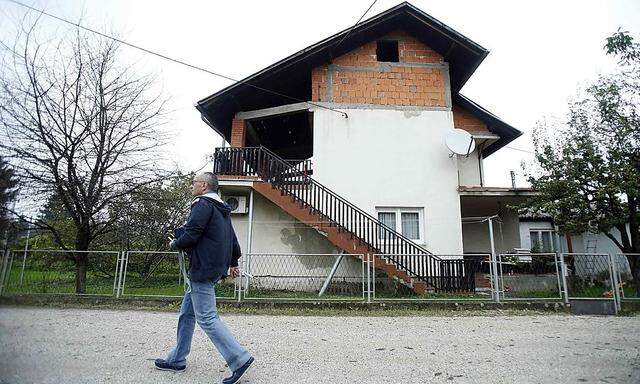 A man passes by the family residence of British aid worker David Haines in Sisak
