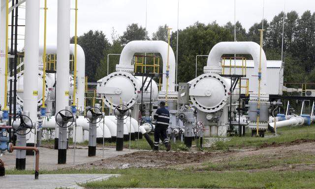A specialist walks past pipes from Latvijas Gaze´s underground gas storage facility in Incukalns