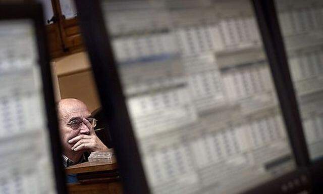 A broker works at the Stock Exchange in Madrid Thursday Nov. 25, 2010. Investors kept pressure on Por