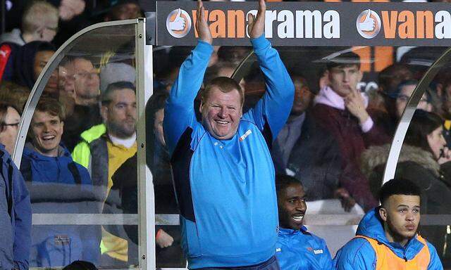 Reserve Goalkeeper Wayne Shaw of Sutton United applauds the Arsenal fans as they sing Who ate all t