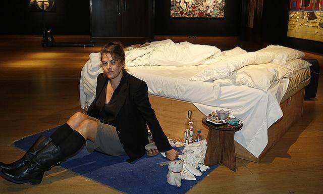 Artist Emin poses with her conceptual artwork ´My Bed´ at Christie´s auction house in London