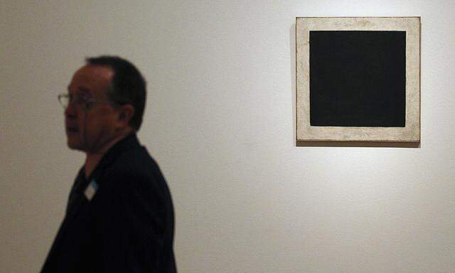 A man stands next to ´Black Square´, a painting by Malevich, during the media preview of ´The Hermitage in the Prado´ exhibition in Madrid