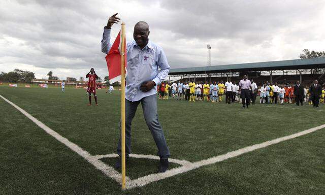 Former Cameroon soccer player Roger Milla dances at the corner flag after meeting young Kenyan players in the capital Nairobi