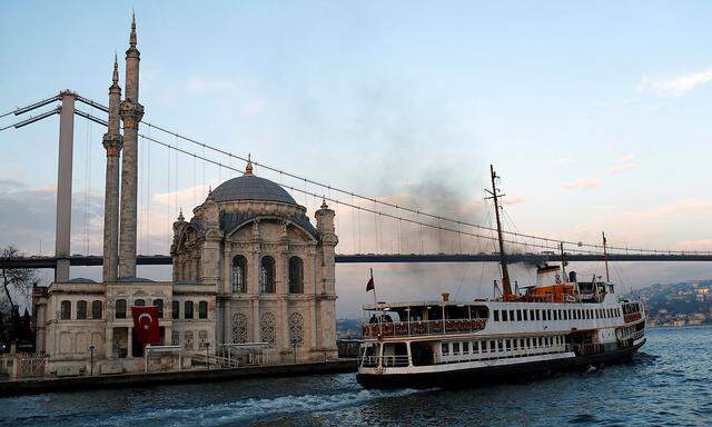 A ferry, with the Ottoman-era Mecidiye mosque in the background, leaves from Ortakoy pier in Istanbul