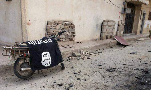 A flag belonging to the Islamic State fighters is seen on a motorbike after forces loyal to Assad recaptured the historic city of Palmyra