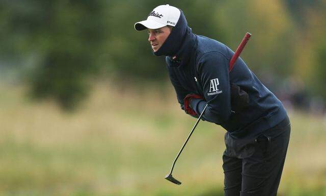 Bernd Wiesberger of Austria wears gloves and scarf in cold weather during Day One of the British Mas