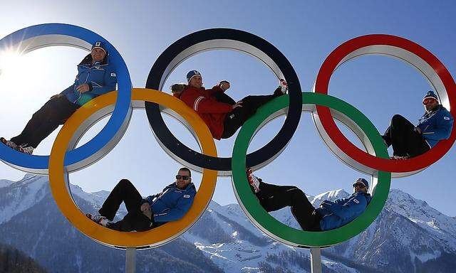 Austrian alpine skiers Georg Streitberger, Klaus Kroell, Max Franz, Joachim Puchner and Romed Baumann pose for a photograph in the Olympic rings at the Olympic athletes mountain village in Rosa Khutor near Sochi