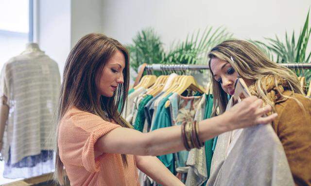 Two women shopping for clothes in a boutique model released Symbolfoto property released PUBLICATION