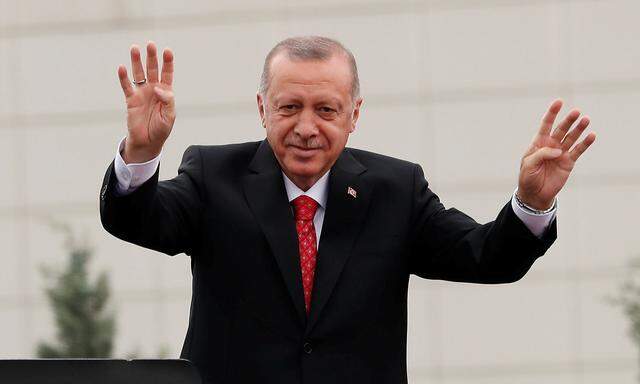 Turkish President Erdogan greets his supporters during a ceremony in Istanbul