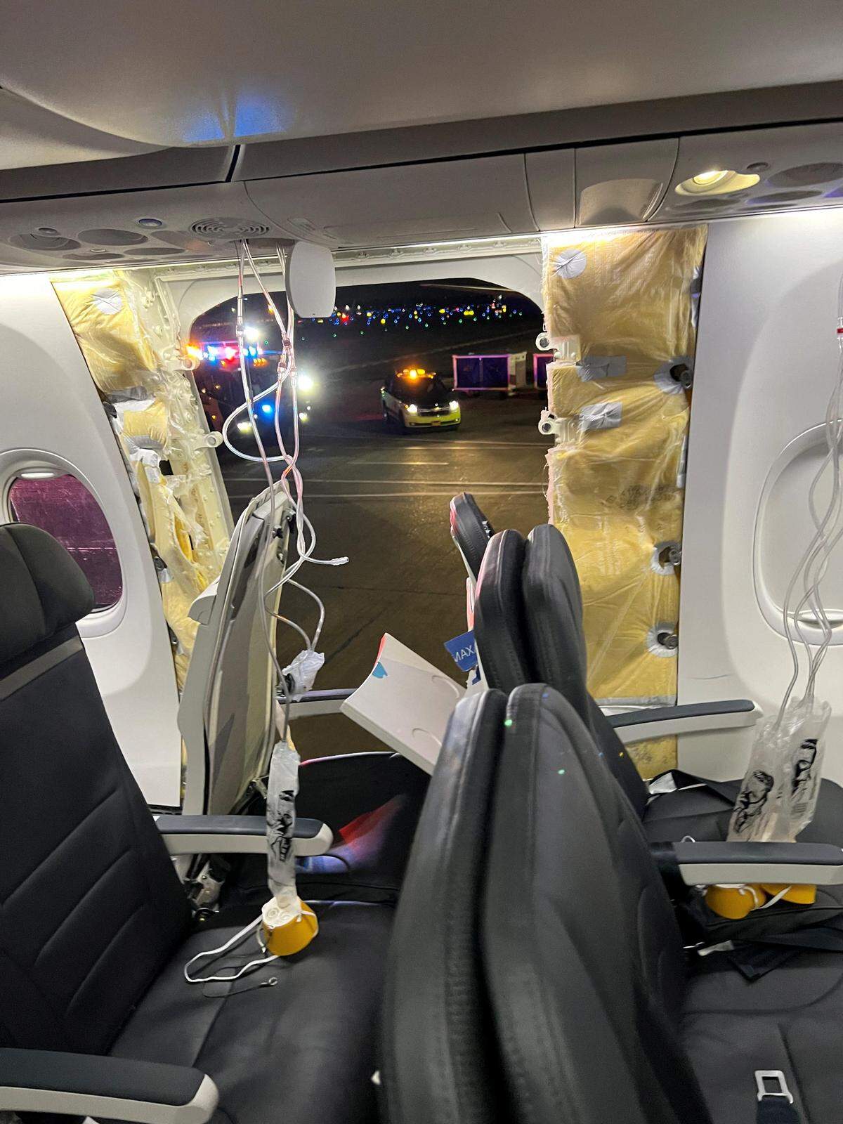 Breathing masks next to a hole in the plane.