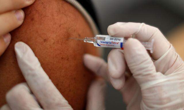 A doctor vaccinates a patient as part of the start of the seasonal influenza vaccination campaign in Nice