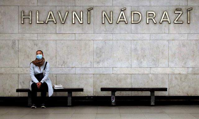 FILE PHOTO: A commuter wearing a protective mask waits for a subway train in Prague