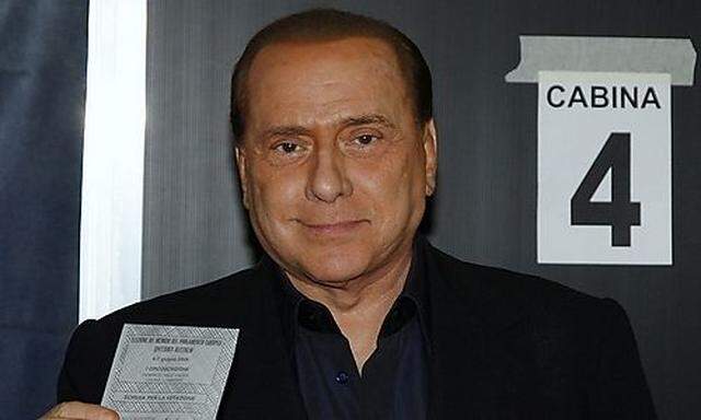 Italian PM Berlusconi votes at a polling station in Milan.