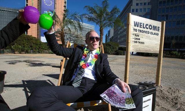 An activist takes part in a demonstration outside the European Commission headquarters, in Brussels
