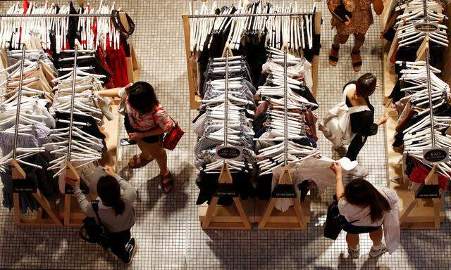 FILE PHOTO: Women shop for clothes on a store in a shopping mall in Sydney