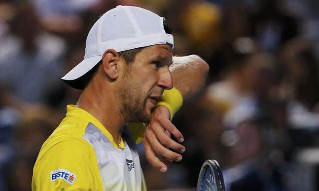 Jurgen Melzer of Austria wipes his face during his men's singles match against Tomas Berdych of Czech Republic at the Australian Open tennis tournament in Melbourne