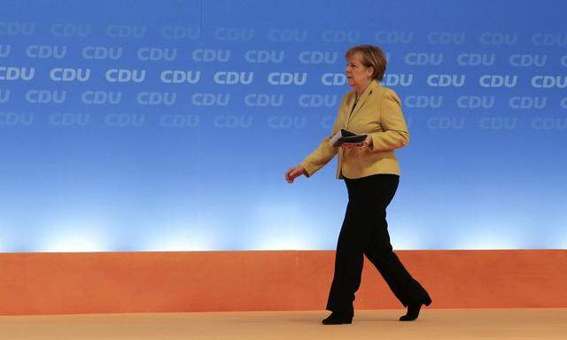 German Chancellor and CDU leader Merkel walks on stage during the party convention in Cologne