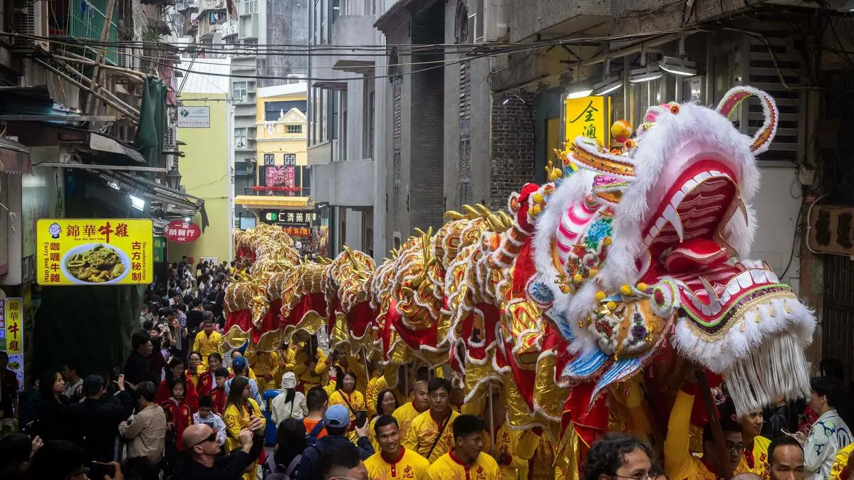 Performers take part in a 238-meter-long dragon dance on a street during celebrations on the first day of the Lunar New Year of the Horse in Macau on February 17, 2026. (Photo by Eduardo Leal / AFP)