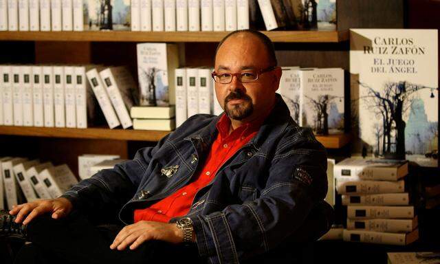 FILE PHOTO: Spanish writer Carlos Ruiz Zafon attends a photo call before the presentation on his new book titled 'El juego del Angel', or The game of the Angel, at the Liceu theater