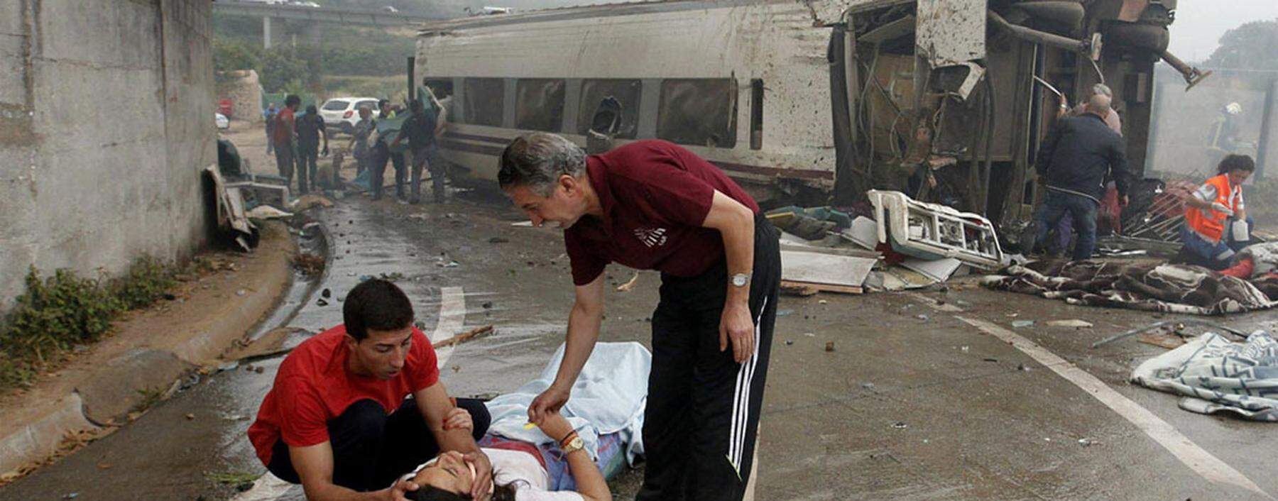 Victims receive help after a train crashed near Santiago de Compostela