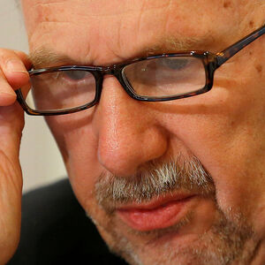 FILE PHOTO: ECB Governing Council member Nowotny adjusts his glasses during a news conference in Vienna