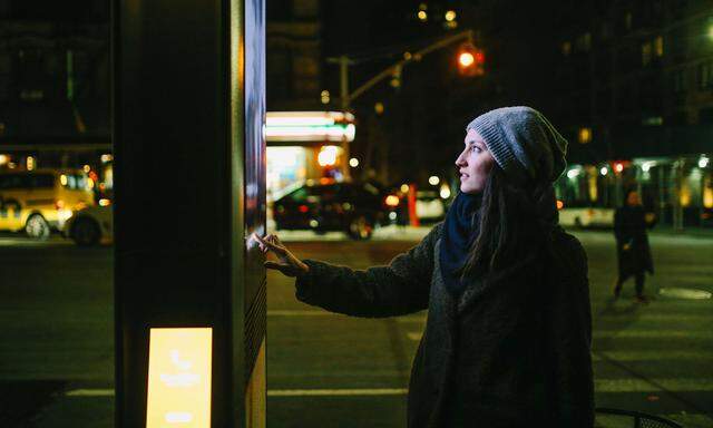 Woman using touch screen city display