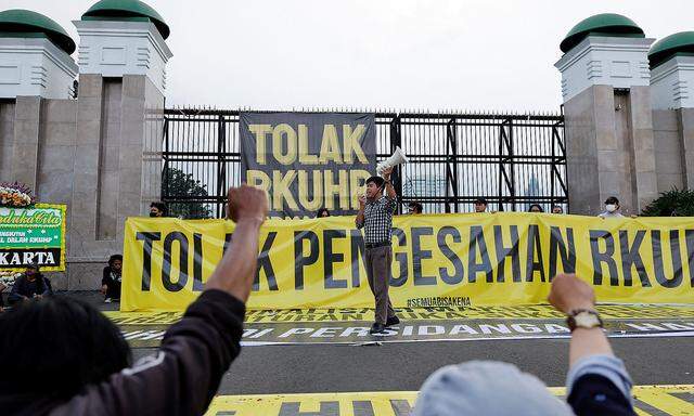 People protest against a new criminal code in Jakarta