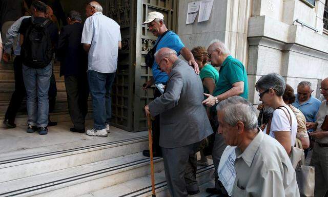 People enter a National Bank branch in Athens
