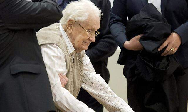 File photo of former Auschwitz bookkeeper Oskar Groening, a 93-year-old former bookkeeper at Auschwitz death camp, arriving for the start of his trial in a courtroom in Lueneburg