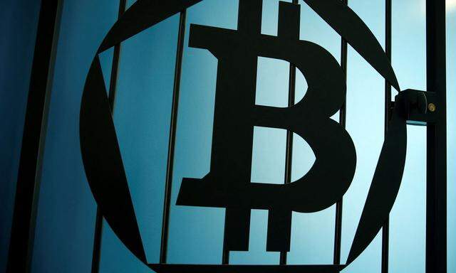 FILE PHOTO: A bitcoin logo is pictured on a door at La Maison du Bitcoin in Paris