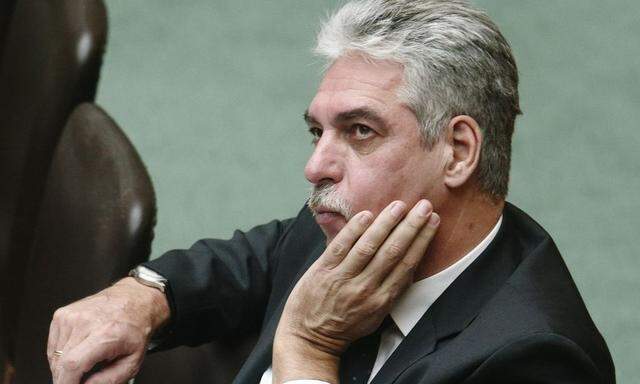 Austrian Finance Minister Schelling sits on the government bench during a session of the parliament in Vienna