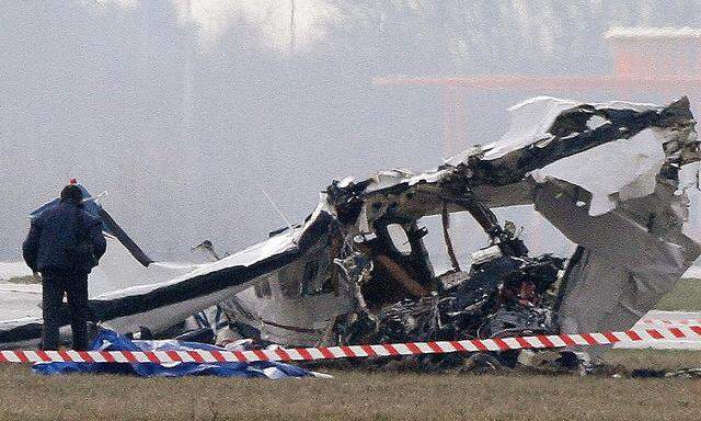 Police photographer inspects the scene of a tourist plane crash at Charleroi airport