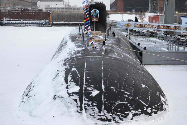 This pool photograph distributed by Russian state agency Sputnik shows the new Imperor Alexander III nuclear submarine during a flag-rising ceremony led by Russia's President at the Arctic port of Severodvinsk on December 11, 2023. (Photo by Kirill IODAS / POOL / AFP)