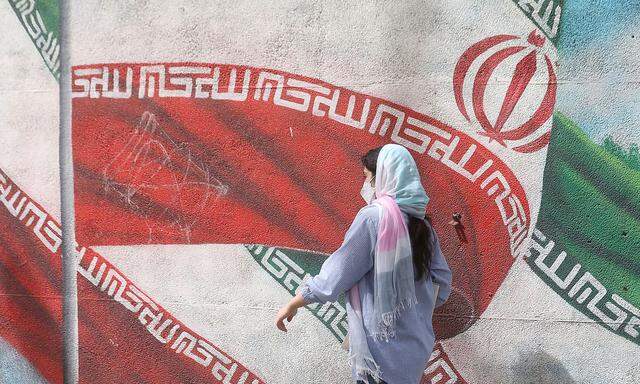 Iranian woman walks in a street in Tehran